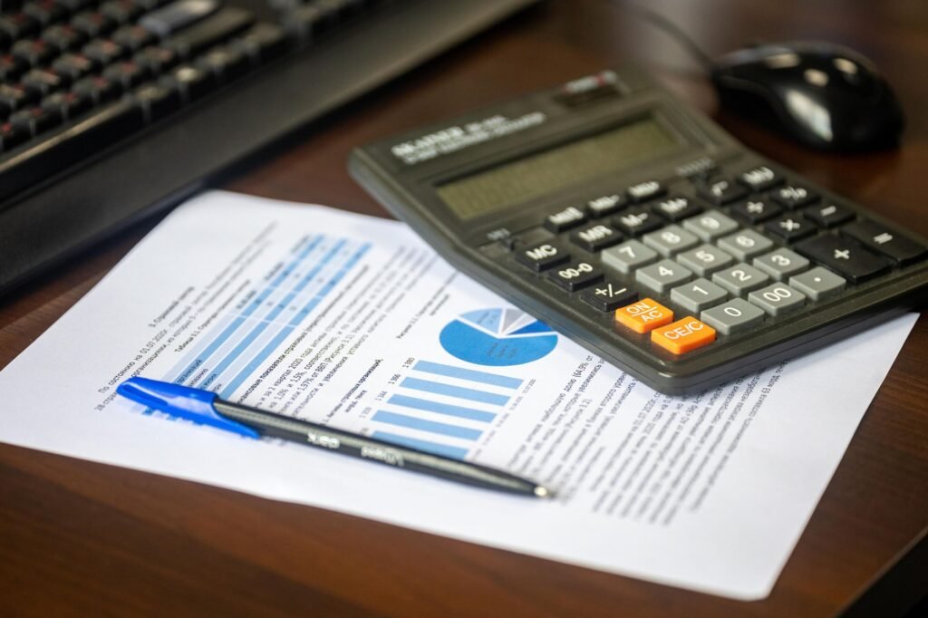 A calculator and retirement documents on a table for financial planning