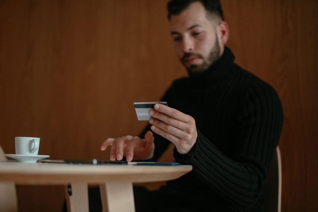 A young adult filling out a credit card application at a store