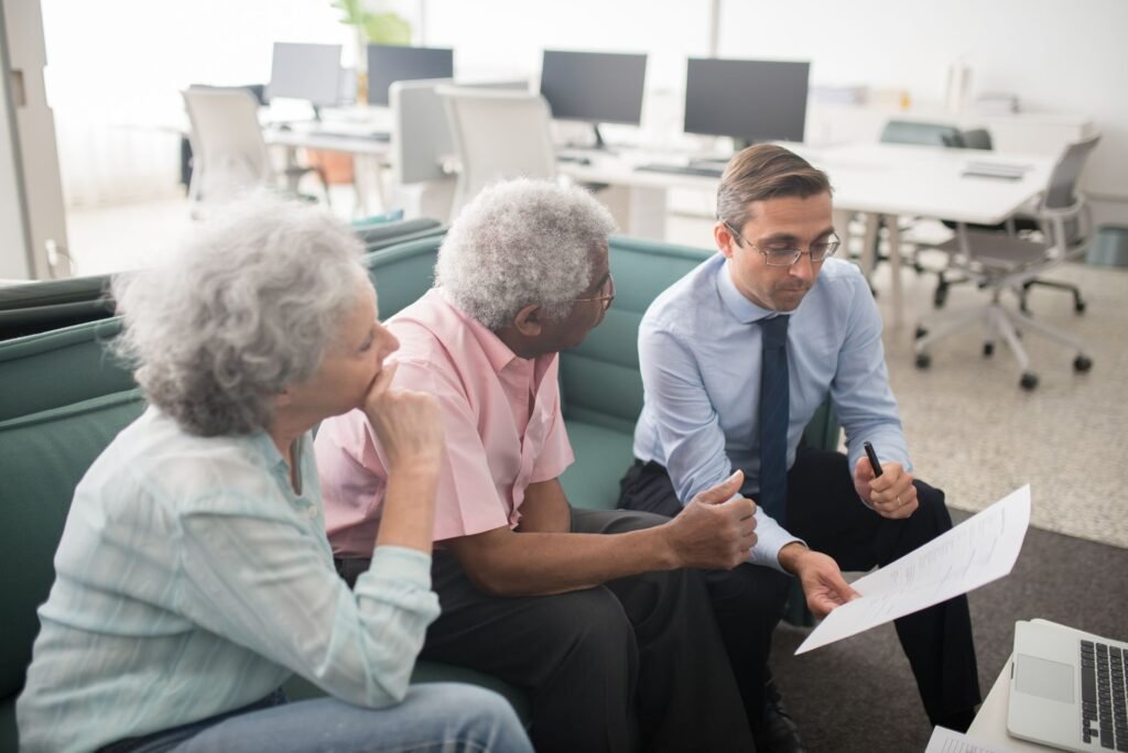 Business professional consults elderly clients in an office setting