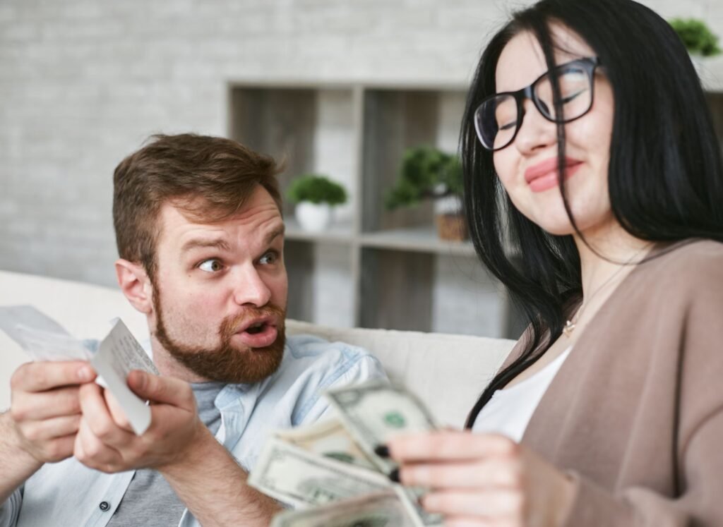 Interracial couple arguing over bills and cash at home