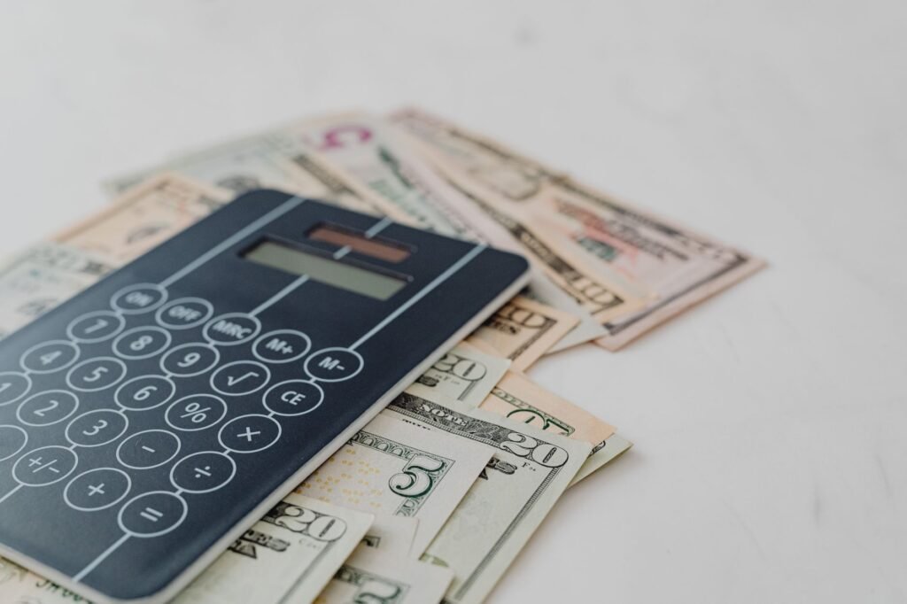 A calculator and credit score report on a desk, symbolizing financial planning