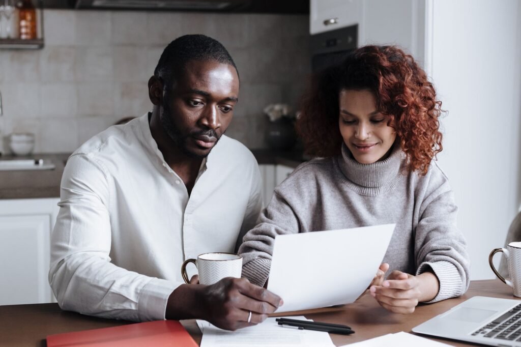 A couple discussing their financial plan together, emphasizing teamwork in budgeting