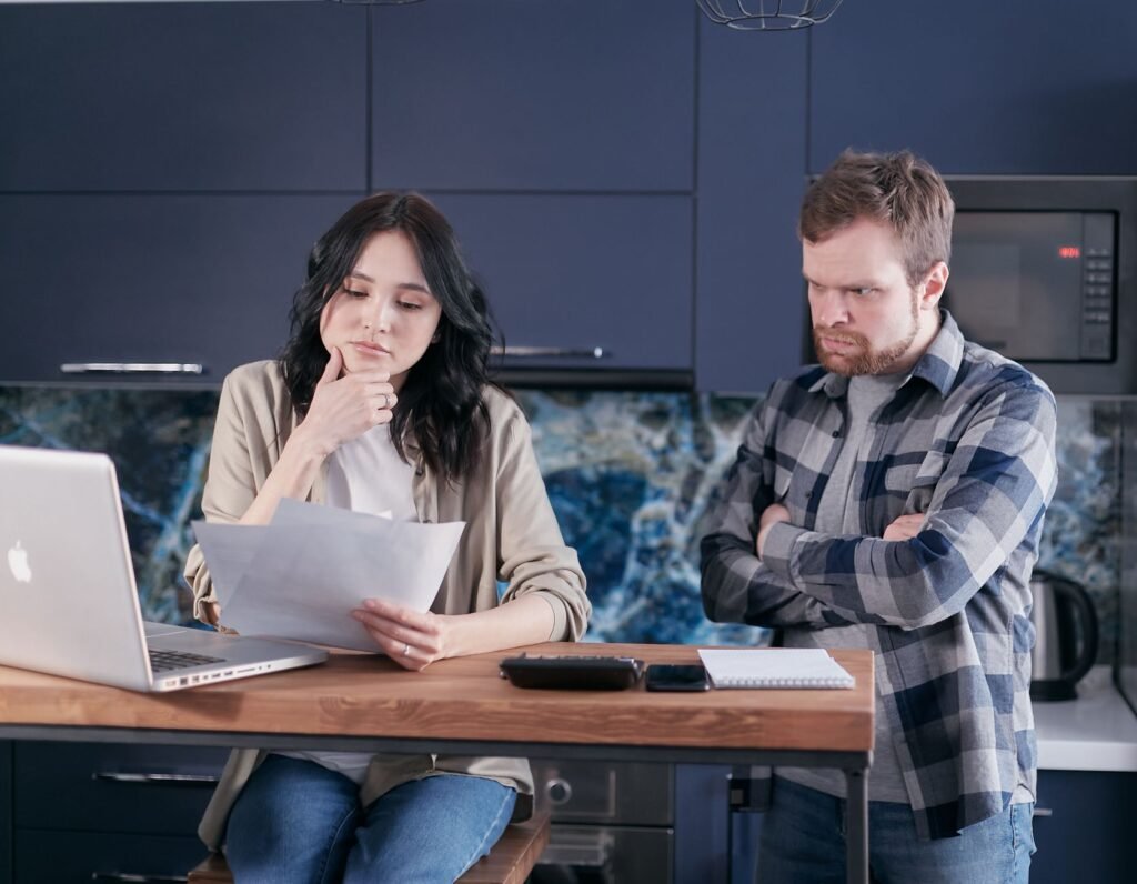 A couple discussing their monthly budget to manage finances effectively