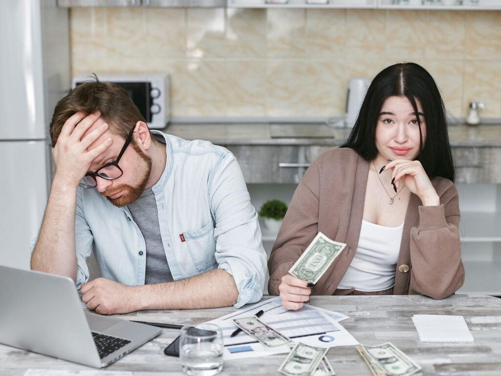 A couple managing their finances in a kitchen setting