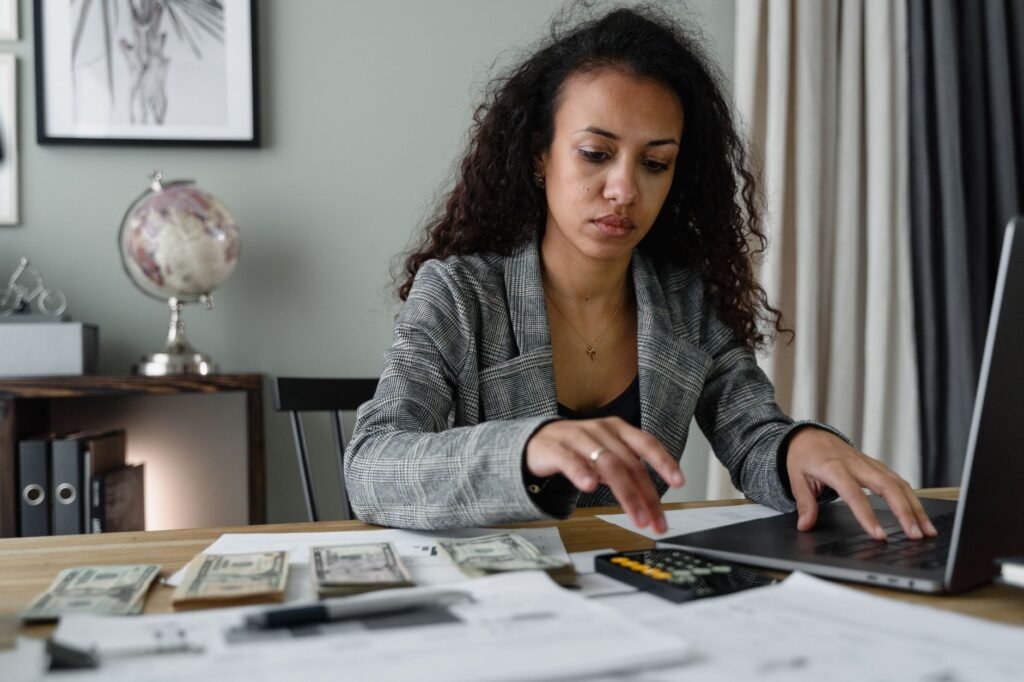 A person managing their budget on a laptop