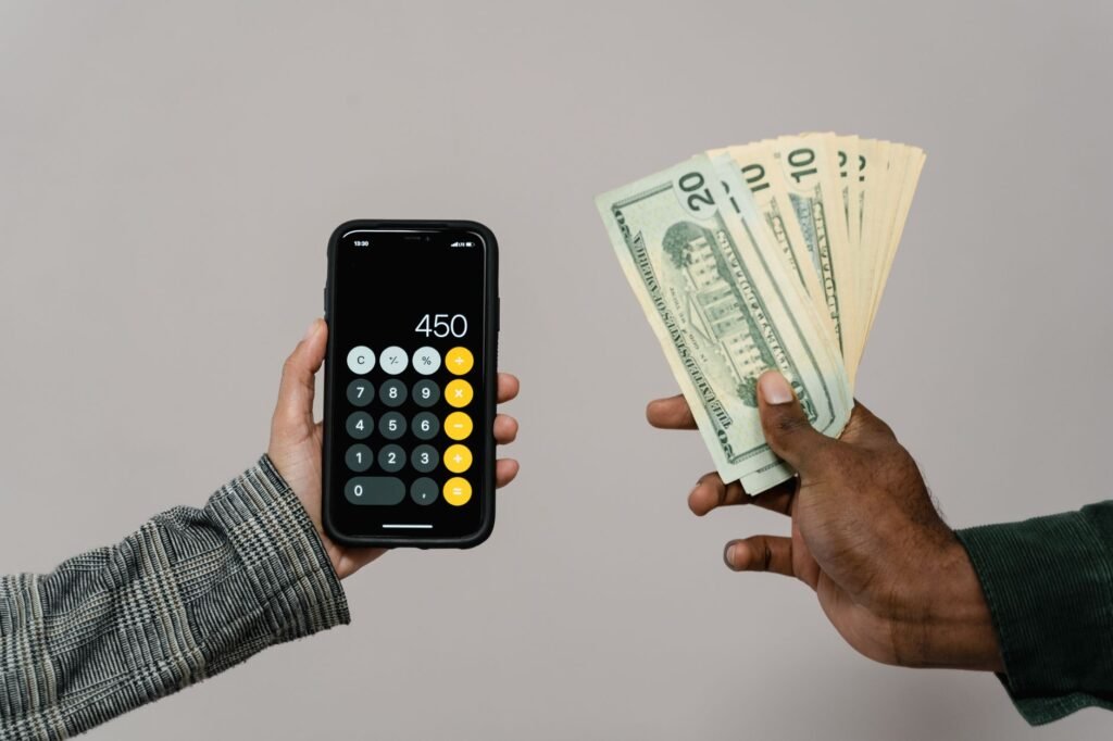 An individual using a budgeting app to track expenses and manage debt