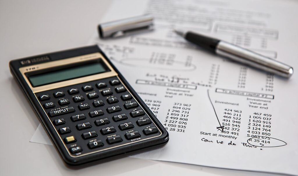 Close-up of financial documents with calculator and pen
