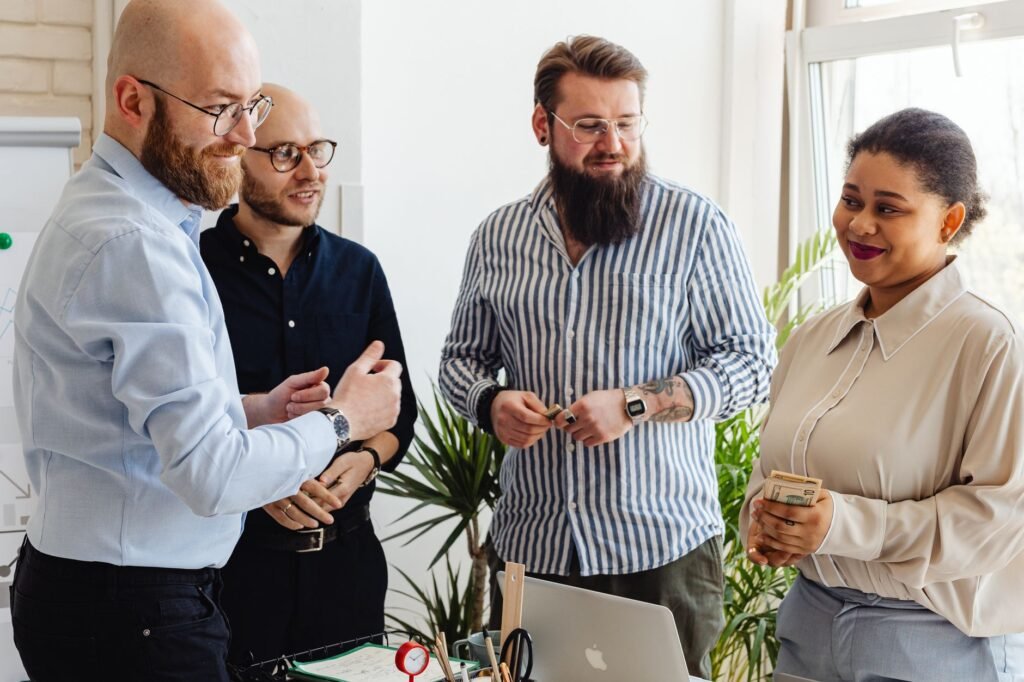 Colleagues sharing ideas and smiling during a team meeting in a modern office