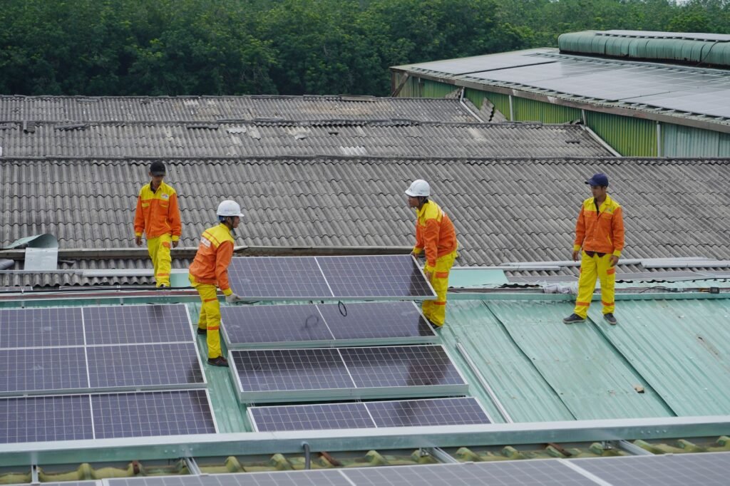 Workers installing solar panels on a roof for sustainable energy solutions